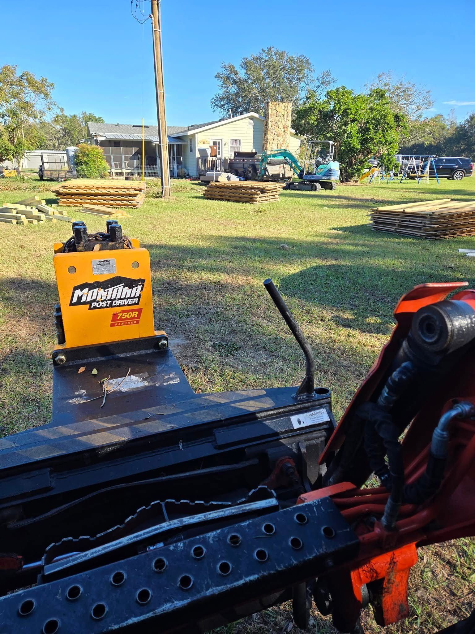 Orange toolbox on a black metal frame in a grassy yard, with houses and trees in the background