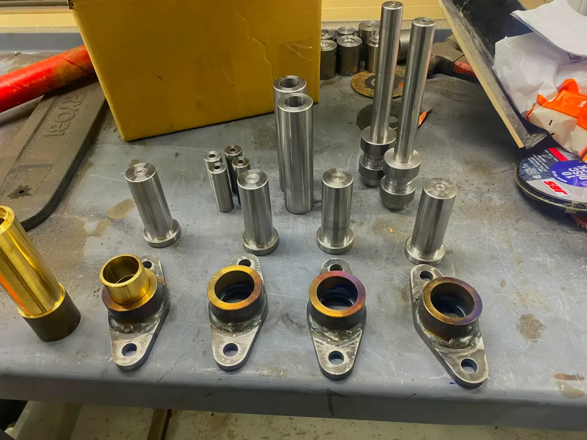 Fabricated and machined parts for a tilt tray