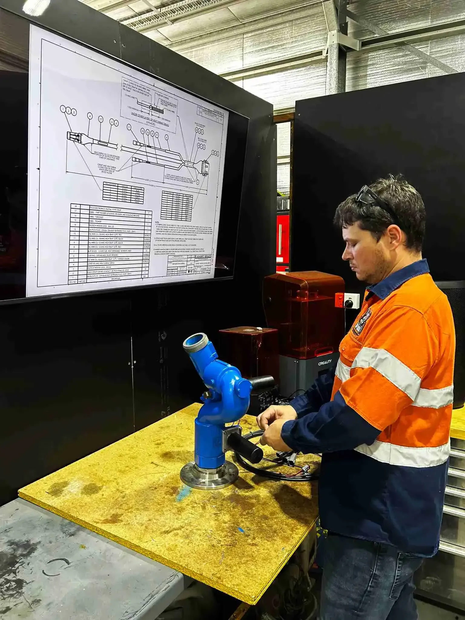 Technician diagnosing electrical faults on water cannon using a schematic diagram on the Gold Coast