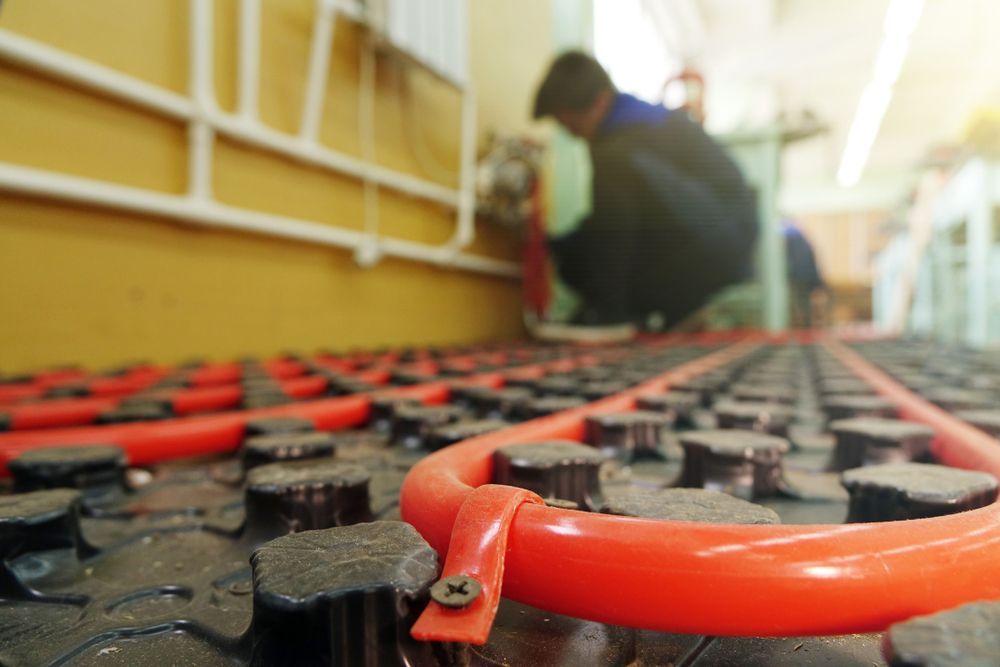 Person Working on a Ship Deck With Red Safety Netting in the Foreground — Southern Trade Services in Launceston, TAS