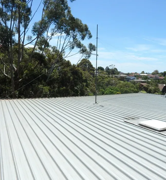 A Flat Metal Roof with Gum Trees in the Background — Southern Trade Services in Launceston, TAS 