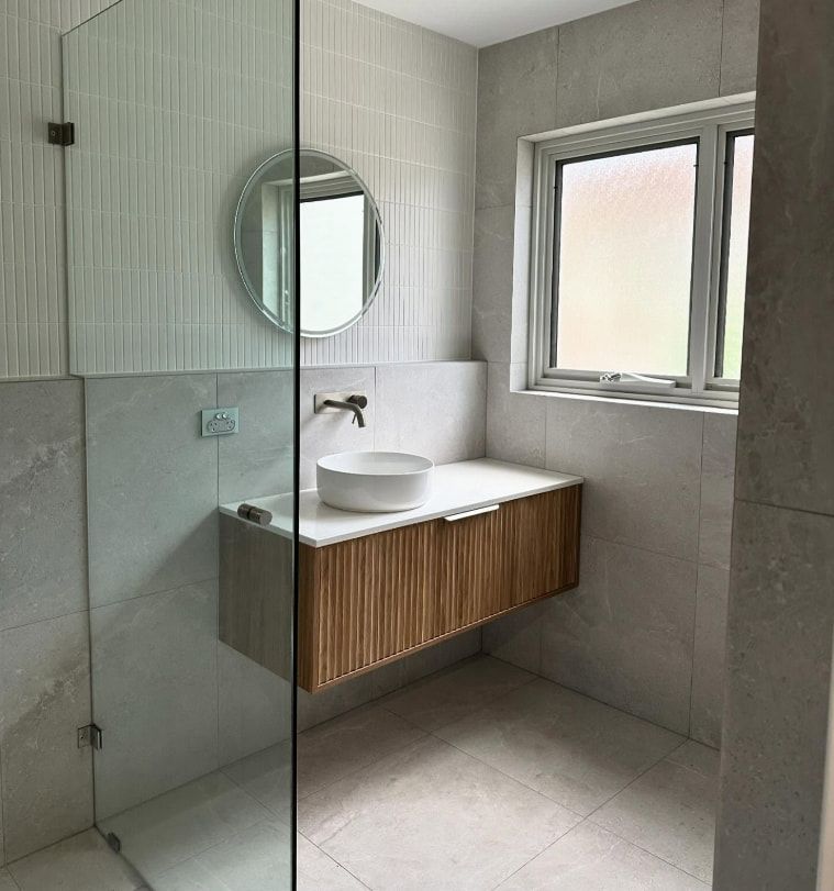 A Bathroom With A Sink , Mirror , And Walk In Shower — Penman Projects In Salamander Bay, NSW