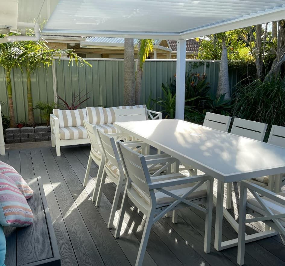 A Patio With A Table And Chairs Under A Canopy — Penman Projects In Salamander Bay, NSW
