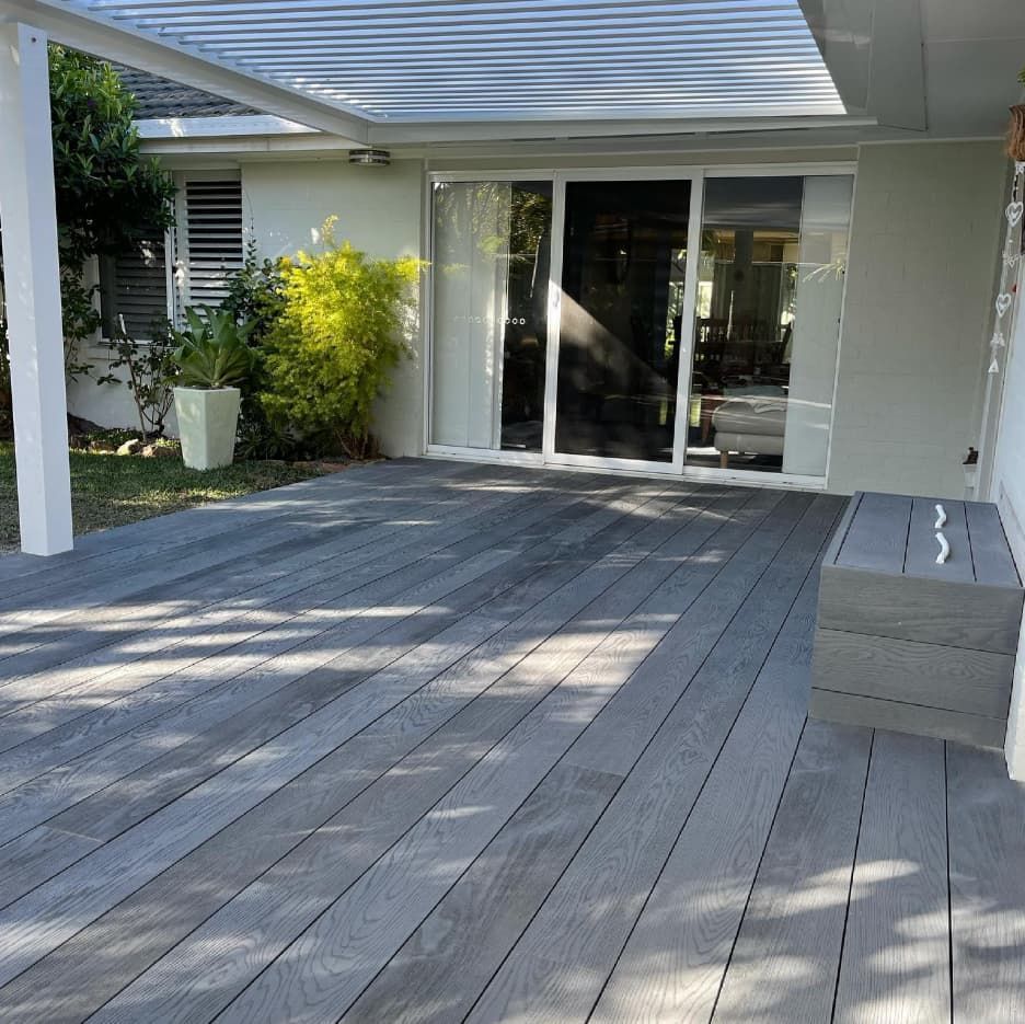 A Wooden Deck With A Sliding Glass Door In The Background — Penman Projects In Salamander Bay, NSW