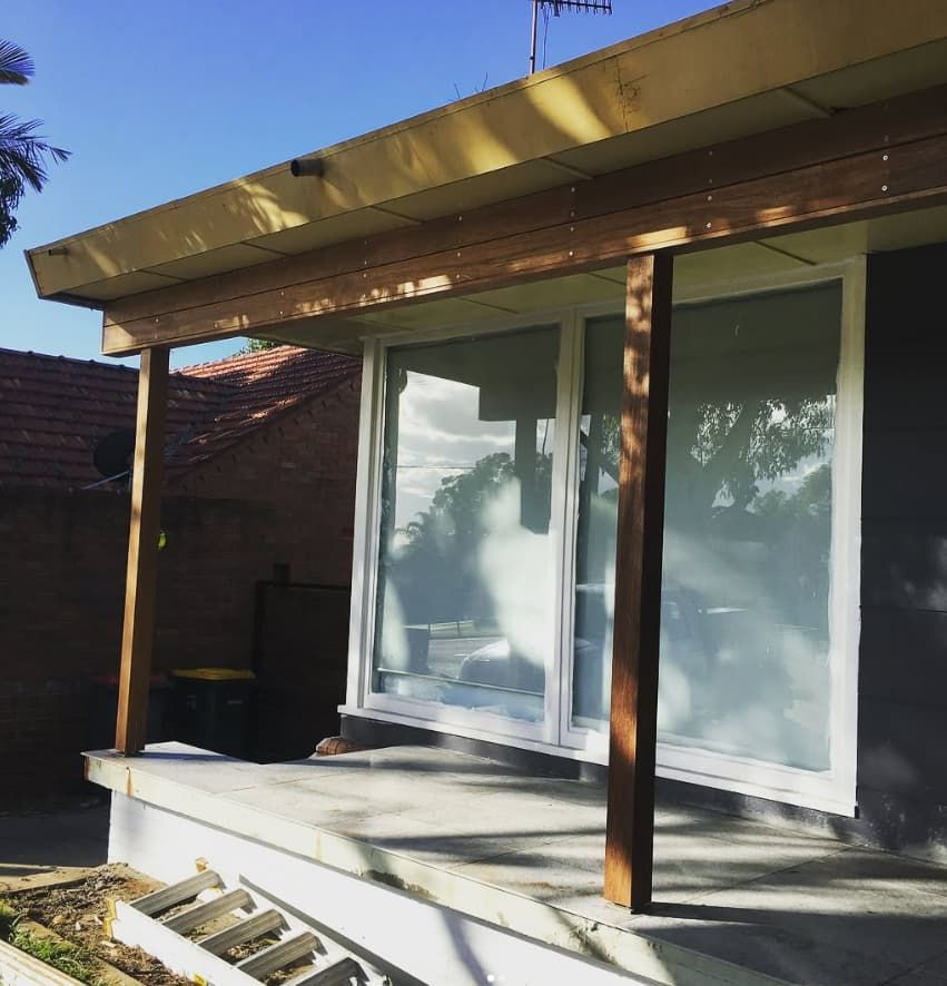 A House With A Porch And Sliding Glass Doors — Penman Projects In Shoal Bay, NSW