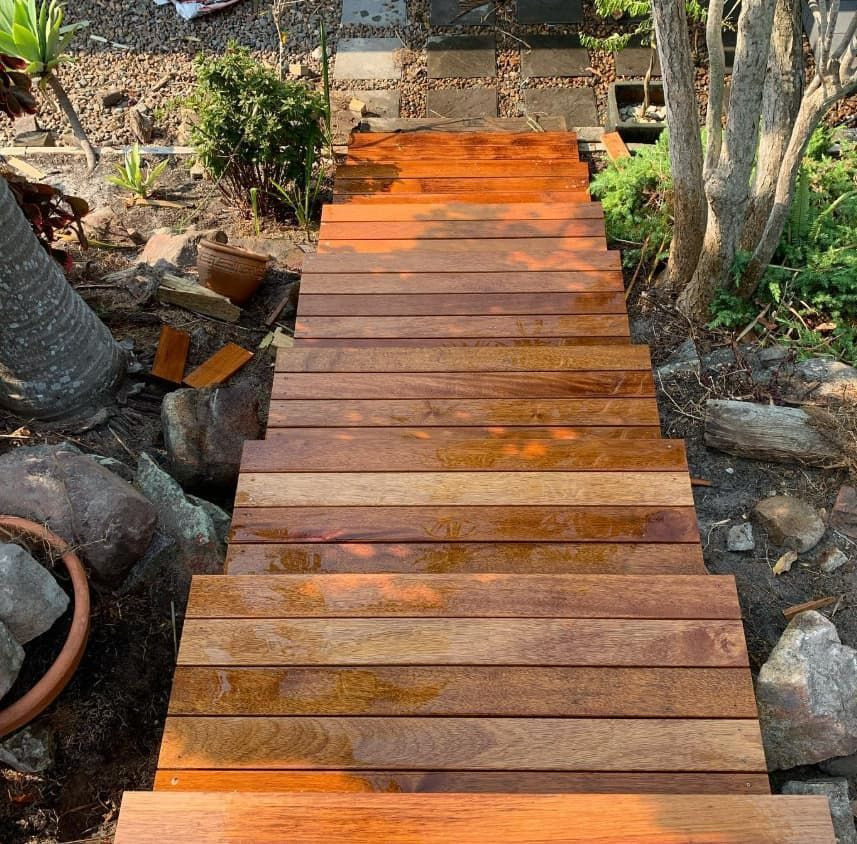 A Wooden Walkway Leading To A Staircase In A Garden — Penman Projects In Anna Bay, NSW