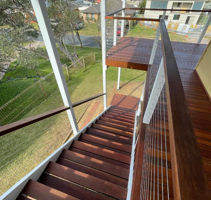 A Set Of Wooden Stairs Leading Up To A Balcony — Penman Projects In Salamander Bay, NSW
