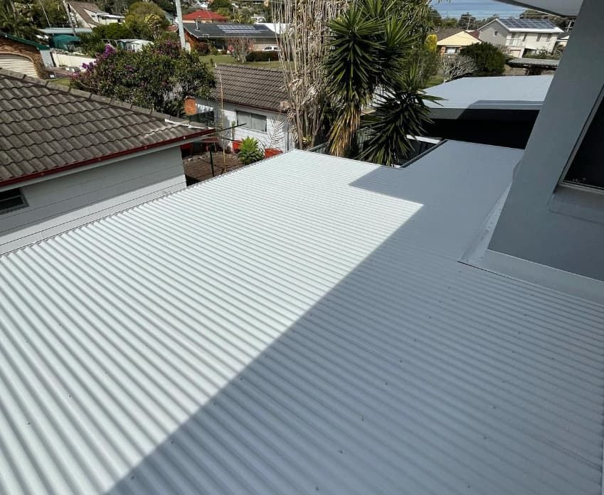 A White Corrugated Metal Roof With A View Of A Residential Area — Penman Projects In Salamander Bay, NSW