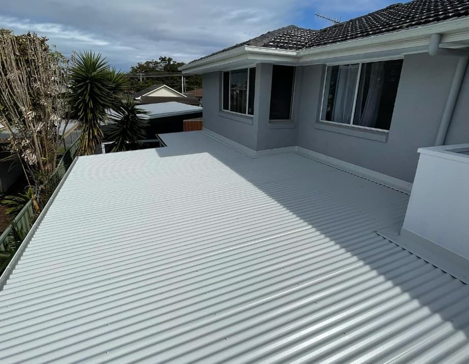 A White Roof Of A House With A Lot Of Windows — Penman Projects In Nelson Bay, NSW