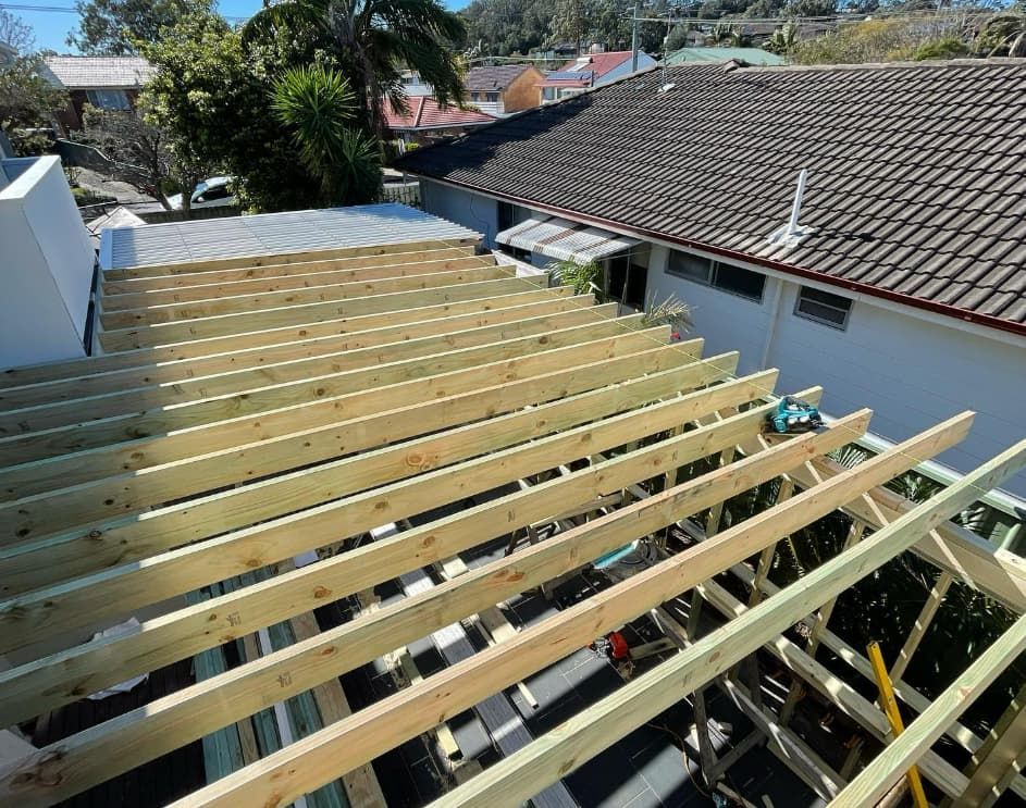 The Roof Of A House Is Being Built With Wooden Beams — Penman Projects In Shoal Bay, NSW