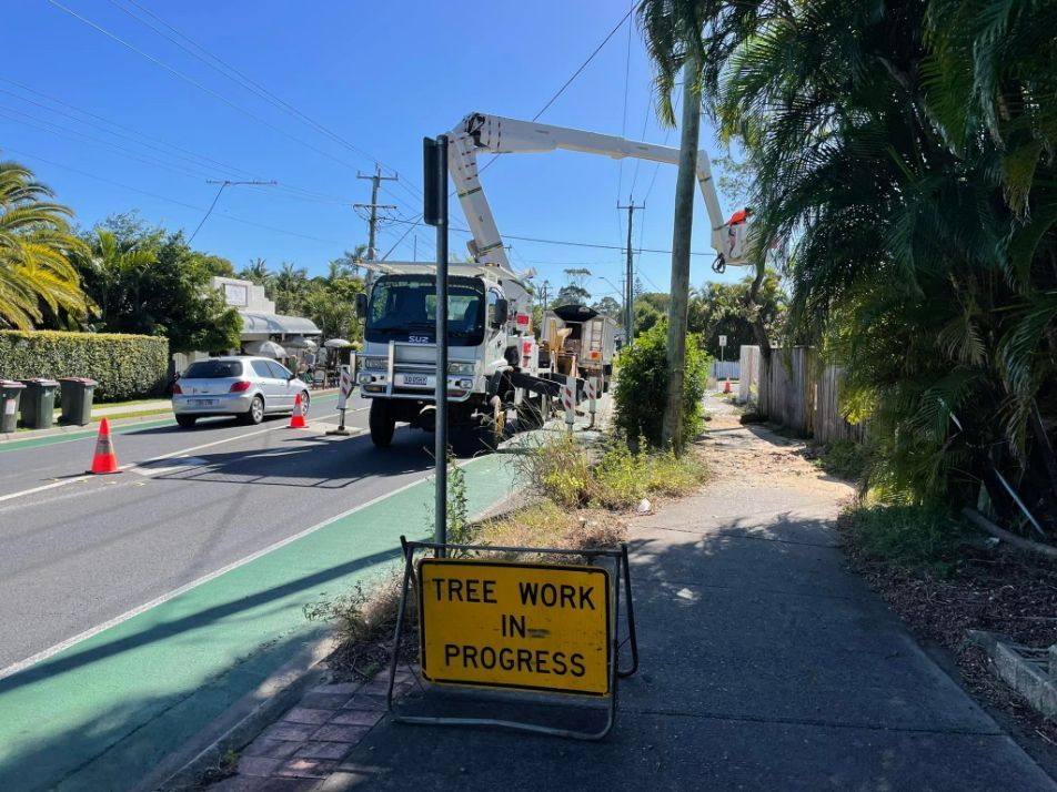 A Yellow Sign on the Side of the Road Says Tree Work in Progress — Tallow Tree Services Pty Ltd in Kyogle, NSW