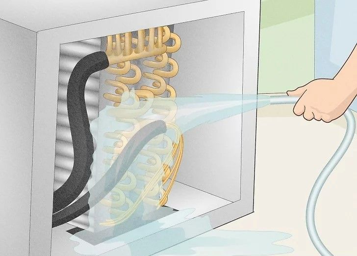 Hand spraying water into an electrical panel with exposed wiring and sparks