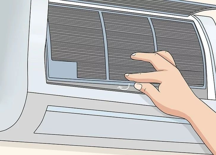 Hand opening a window air conditioner vent with gray slats