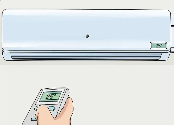 Hand holding a remote aimed at a wall-mounted air conditioner set to 25°