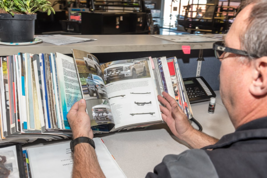 A Man is Researching Truck Parts - Trucks Unique