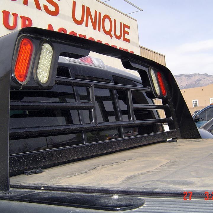 A Truck is Parked in Front of a Sign that Says Unique - Trucks Unique