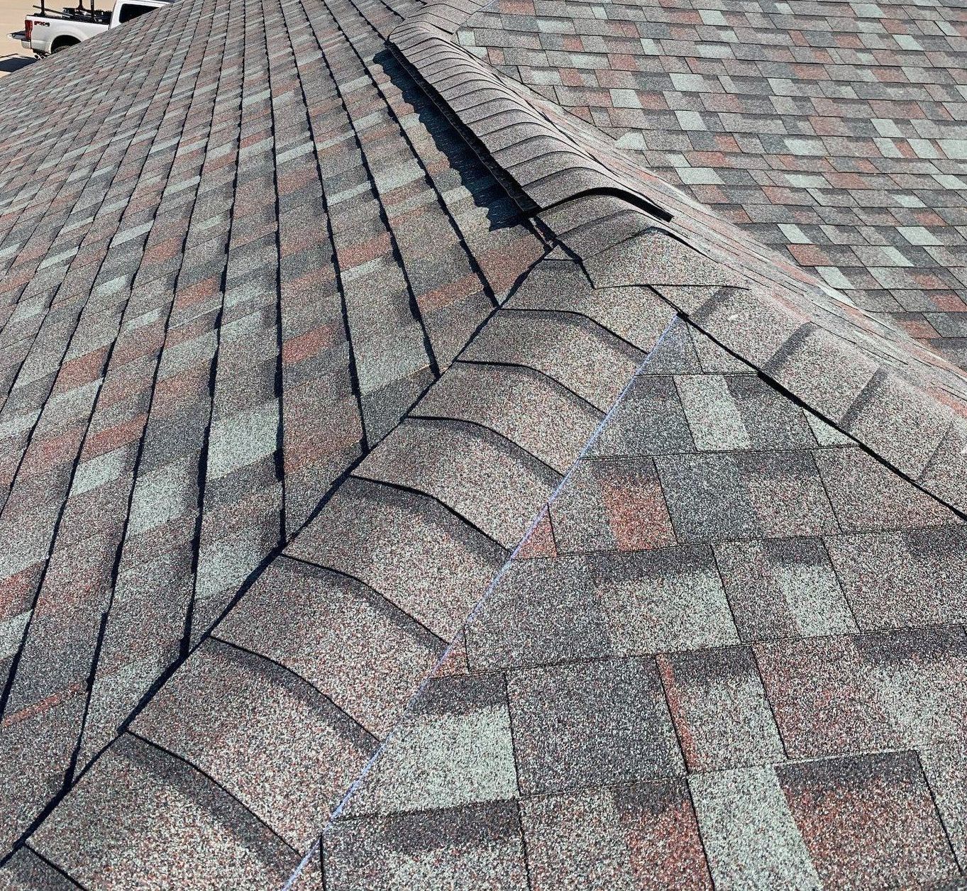 Roof shingles with a raised ridge and a visible seam in the middle
