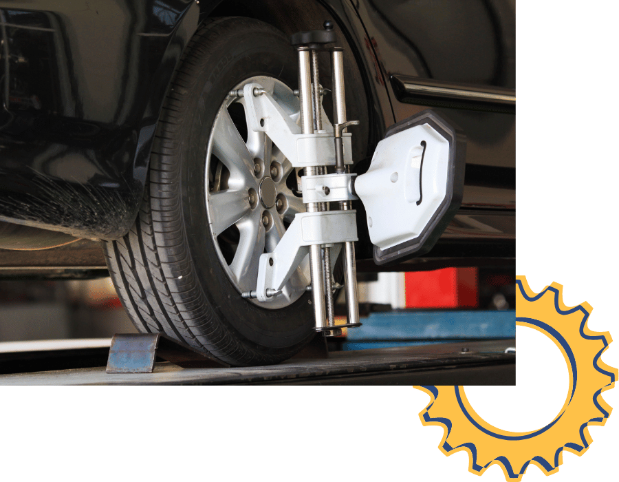 Wheel alignment equipment attached to vehicle tire during alignment service.