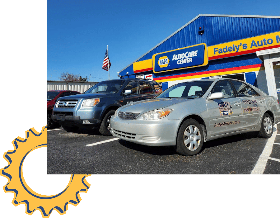 Fadely’s Auto Masters service vehicles parked outside NAPA AutoCare Center.