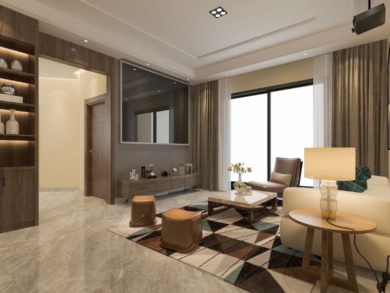 Modern living room with sofa, coffee table, armchairs, wall TV, and warm neutral decor