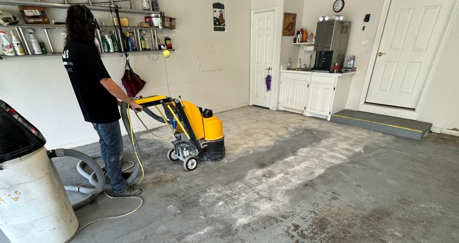 Concrete surface preparation in a garage using a grinding machine