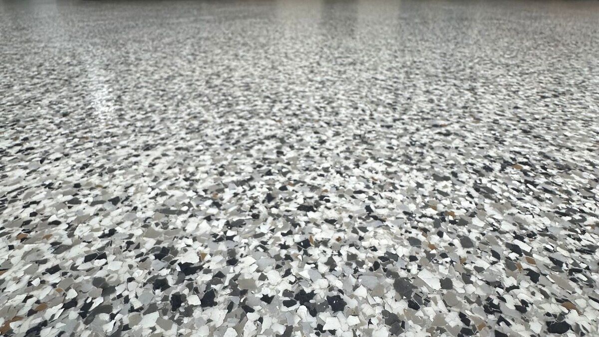 Epoxy garage floor with gray, white, and black chips.