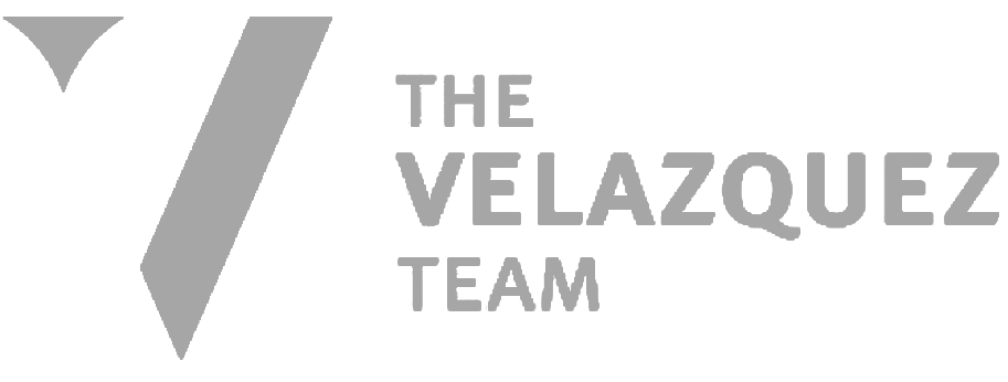 A black and white logo for the velaquez team.
