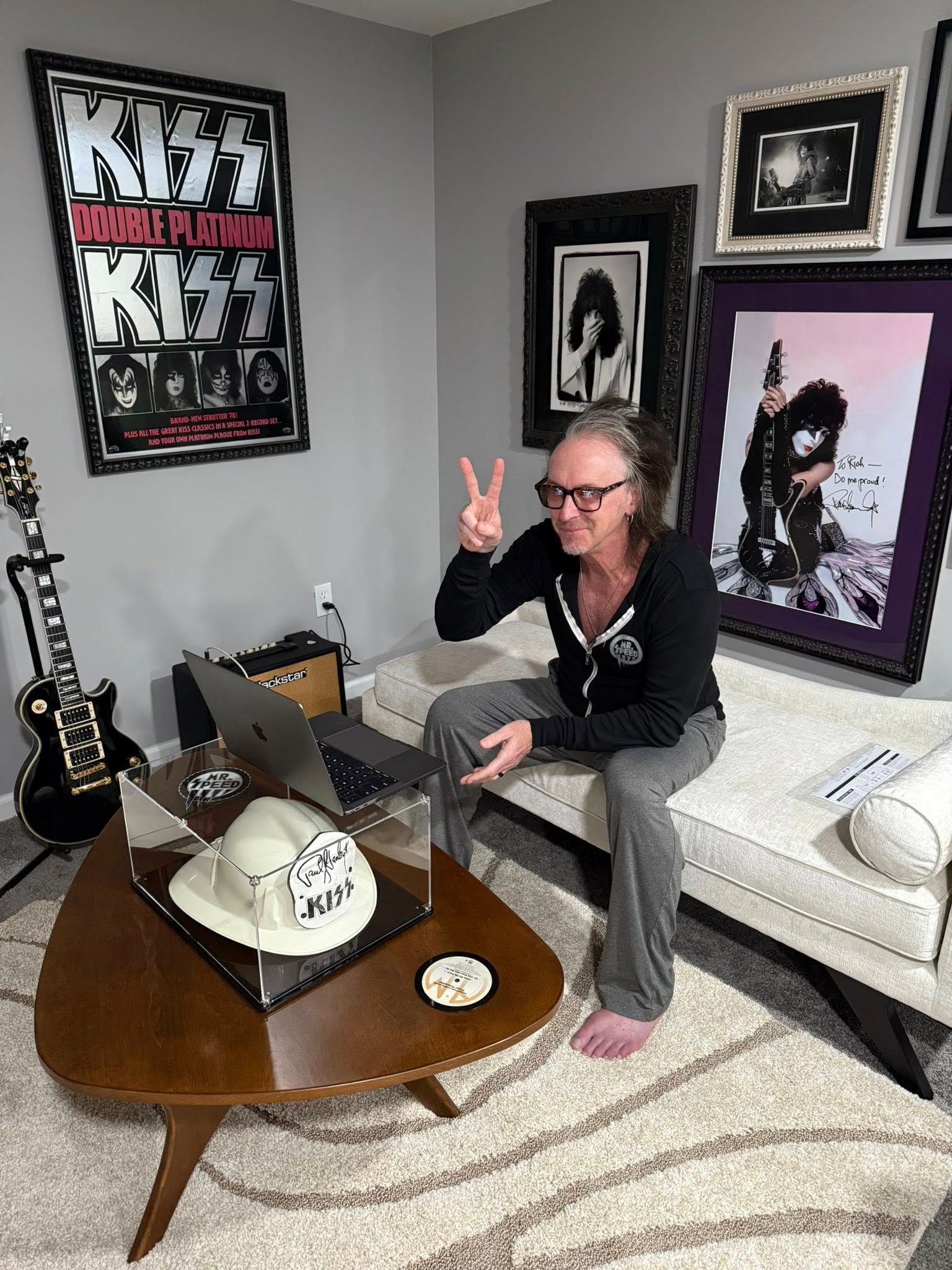 Rich Kosak in living room giving peace sign
