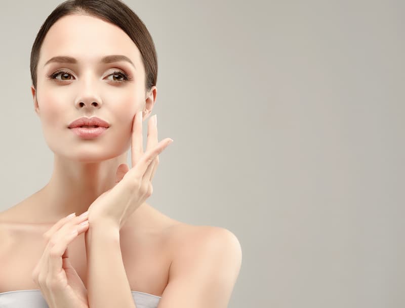 Woman Touching Her Face — Dearborn, MI — Masri Clinic Woman Touching Her Face — Dearborn, MI — Masri Clinic