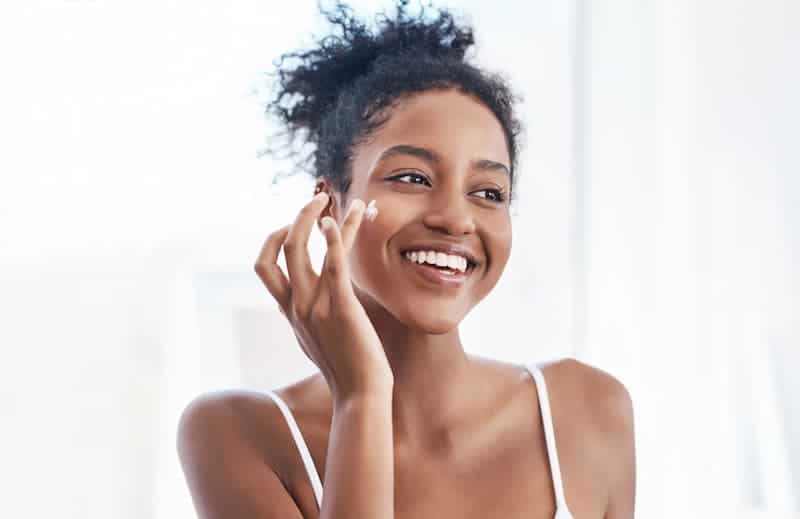 Woman Applying Moisturizer — Dearborn, MI — Masri Clinic Woman Applying Moisturizer — Dearborn, MI — Masri Clinic