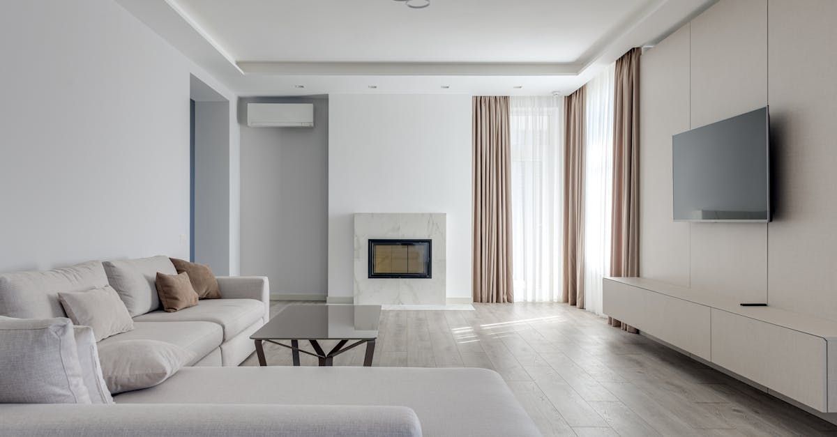 A living room with a couch , television and fireplace.