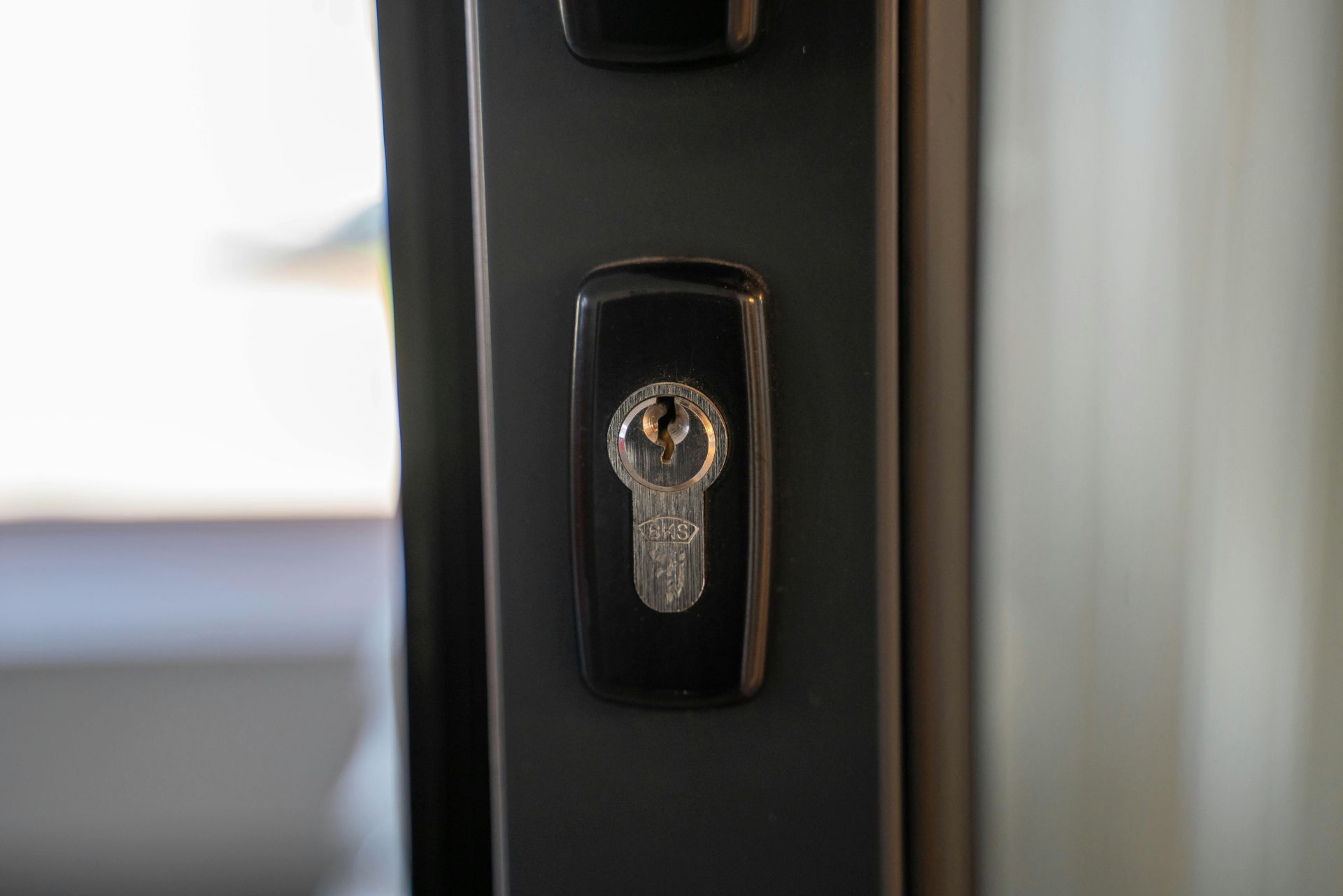 Handing over a key between two people in a blurred indoor setting