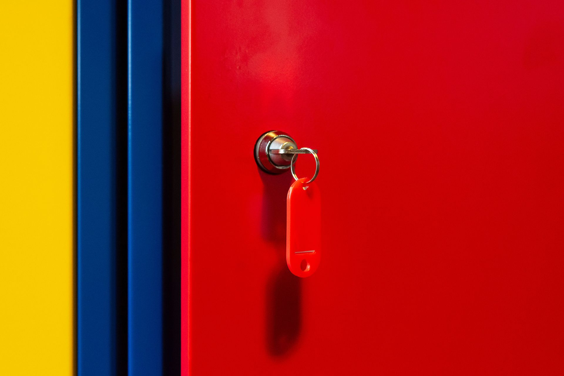 Handing over a key between two people in a blurred indoor setting
