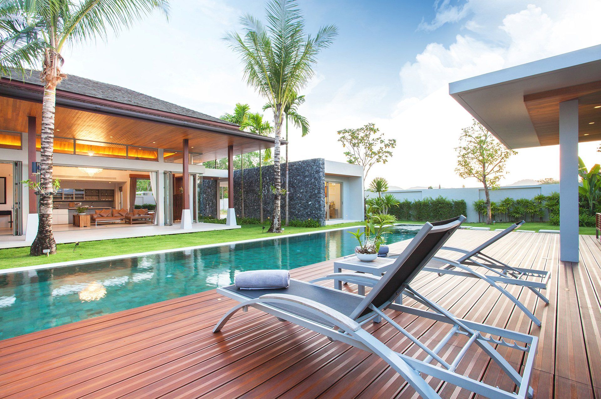 A large house with a swimming pool and a wooden deck
