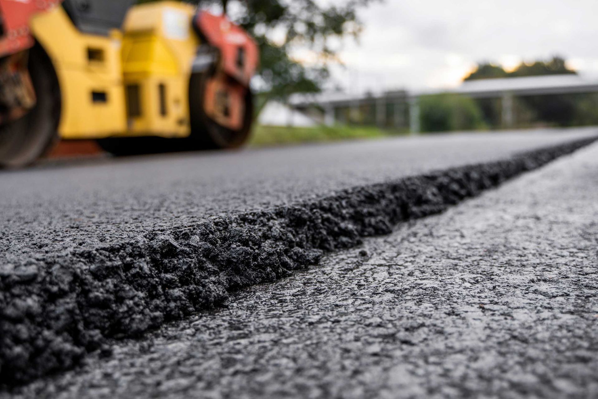 Road construction roller showcasing commercial paving contractor laying hot asphalt. Road construction roller showcasing commercial paving contractor laying hot asphalt.