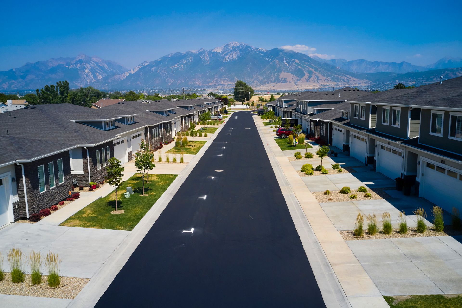 An aerial view of a residential neighborhood with mountains in the background.