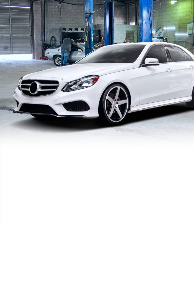 A white mercedes benz is parked in a garage. | J & J Automotive