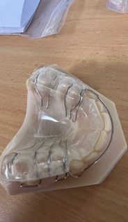 A close up of a dental model on a wooden table.