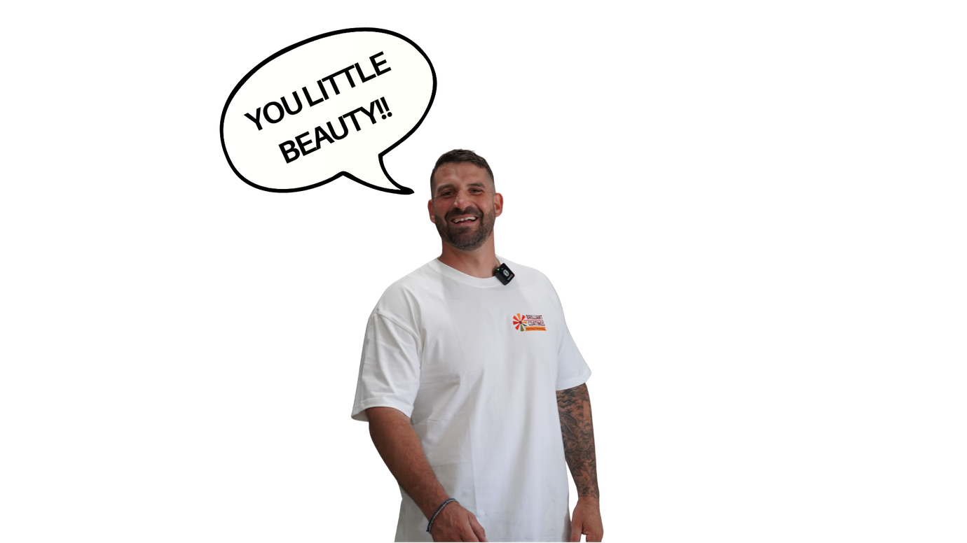 Man in white shirt with a tattoo, speaking 