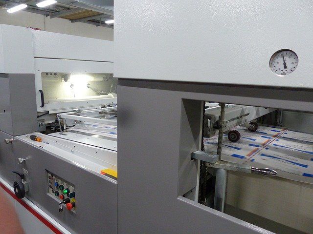 Industrial machine with conveyor and control panel in a factory setting