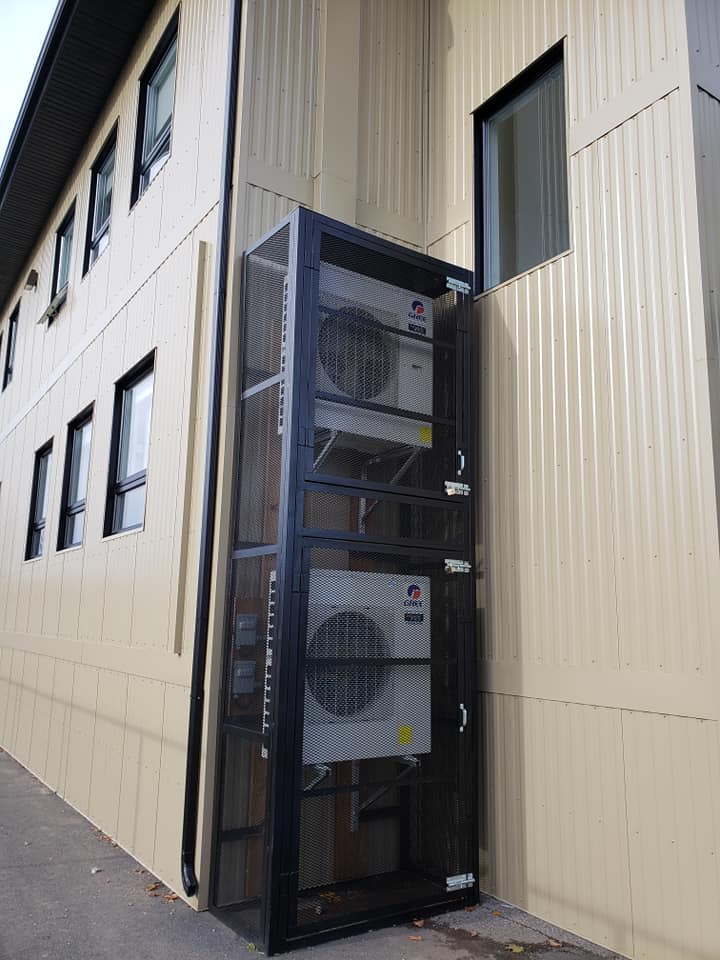Un bâtiment avec trois climatiseurs sur le côté.