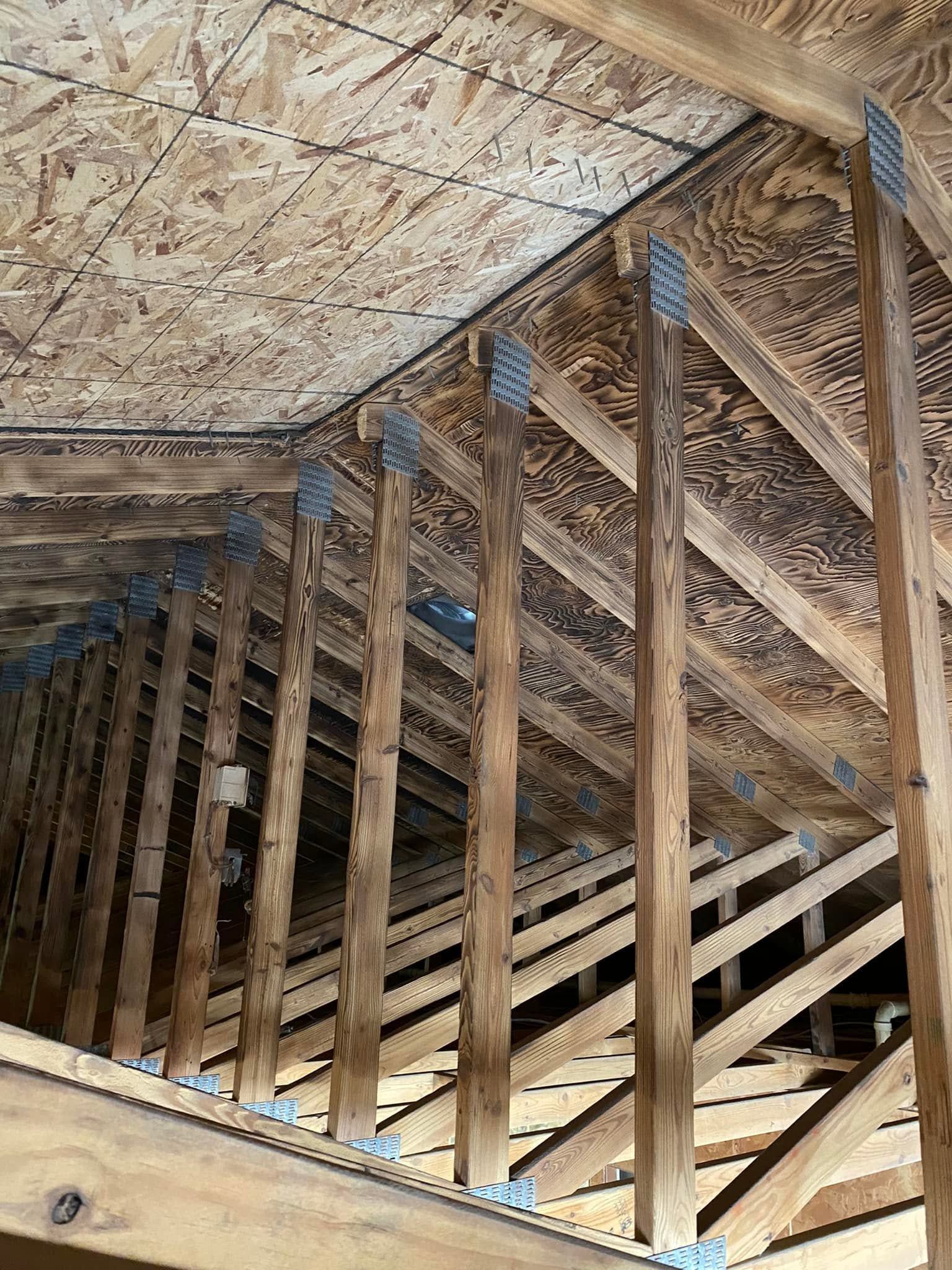 Framed roof attic with wooden trusses and plywood sheathing under construction
