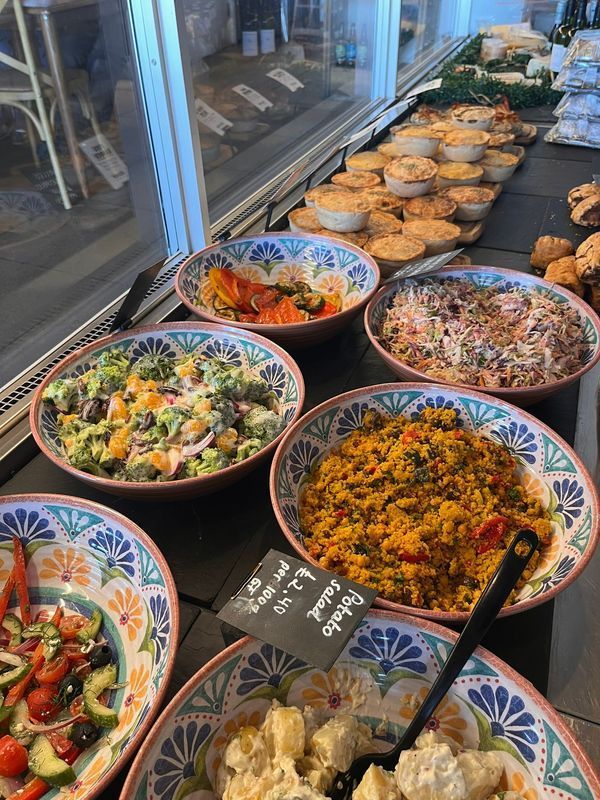 Colorful buffet of assorted salads and dishes in bowls on a counter