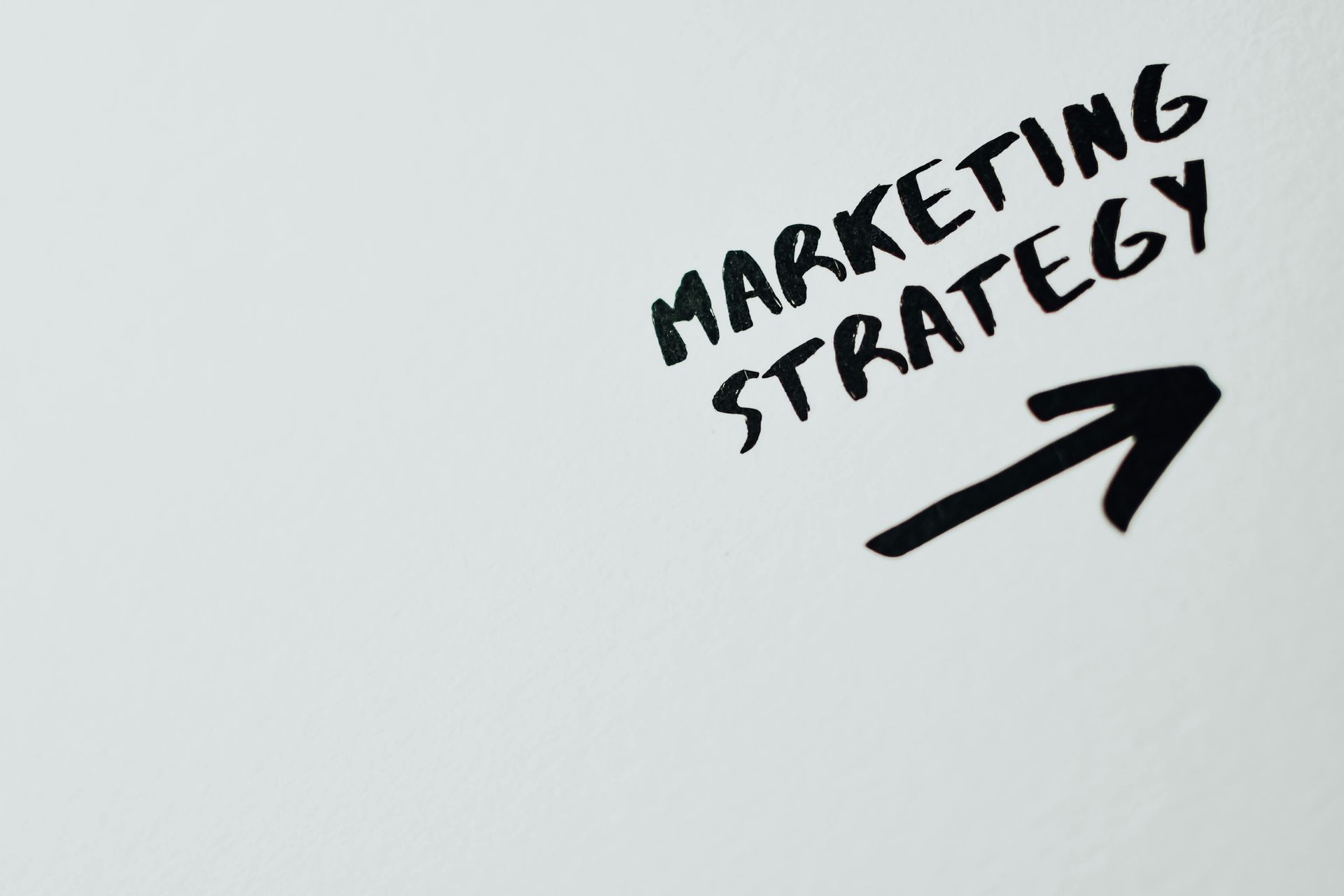 A white board with the words marketing strategy written on it
