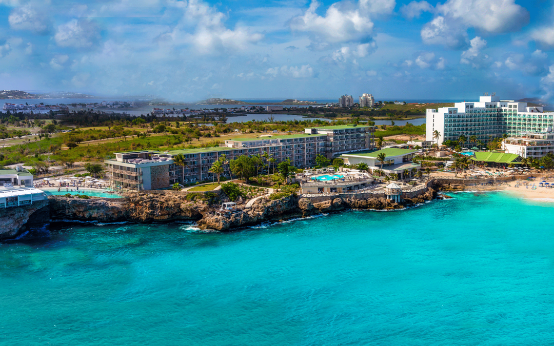 An aerial view of maho beach resort with light blue ocean water