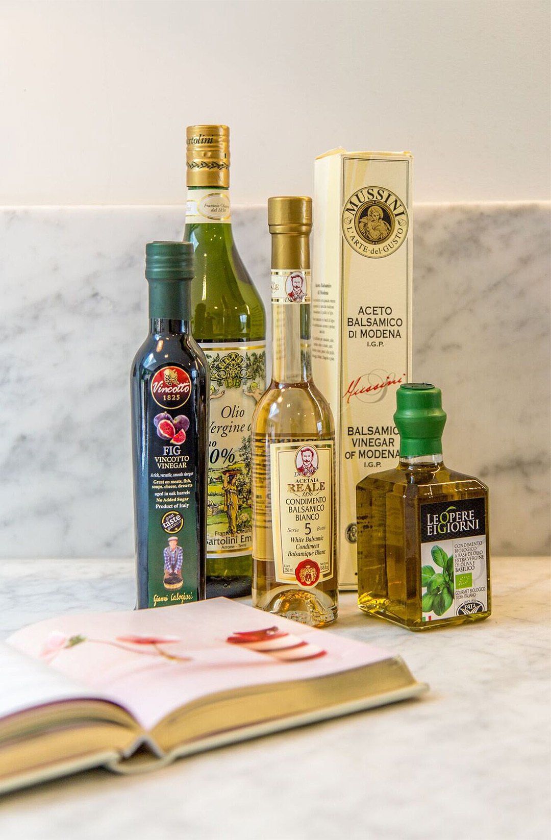 Cookbook and bottles of vinegar and olive oil closeup interior design