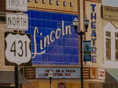 Lincoln Theatre marquee and Route 431 sign on a downtown street corner