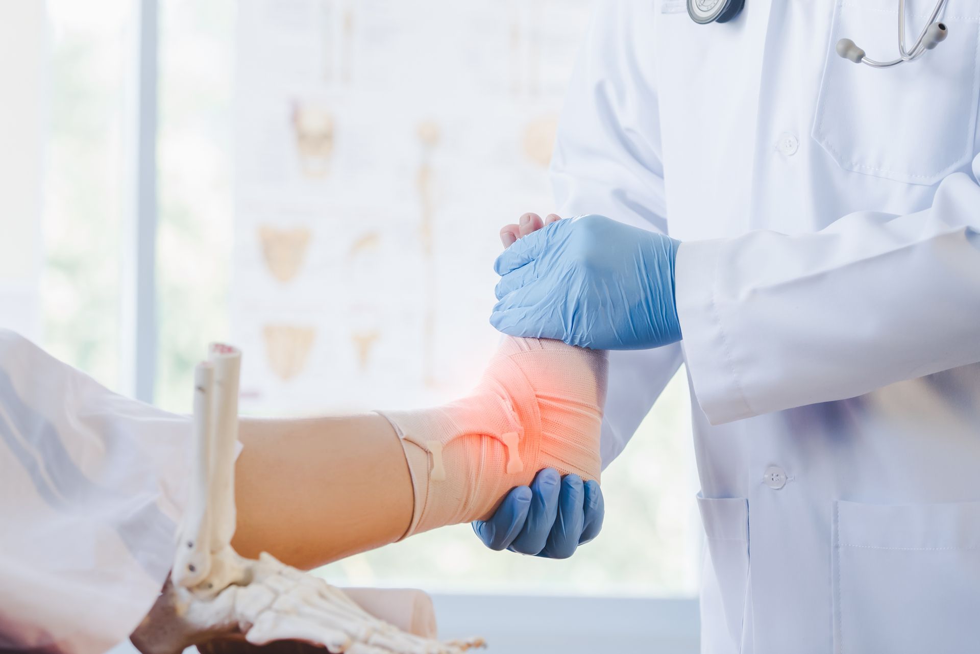 Doctor examining a patient's injured ankle, marked with red, in a medical setting.