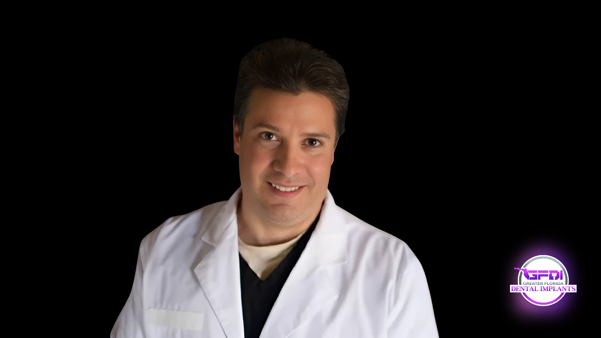 Man in lab coat smiling on black background.