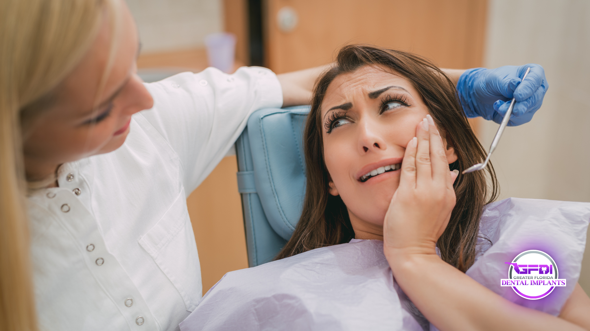 Dental professional examining a patient holding her cheek in a clinic, concerned expression